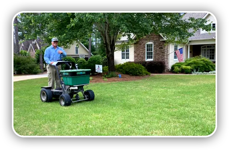 Enviro Green Service Tech Fertilizing lawn