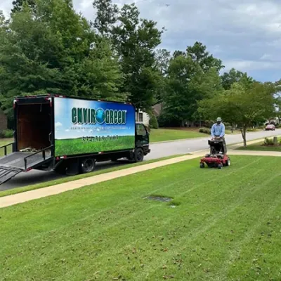 technician aerating lawn