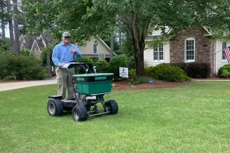 lawn technician fertilizing lawn