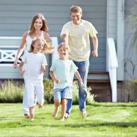 family running and playing outside